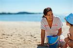 Mother and son playing at beach.