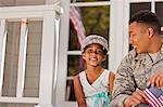 Portrait of a smiling young girl sitting with her father.