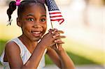 Young girl holding an American flag.