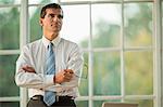 Mid adult businessman standing with his arms crossed.