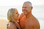 Senior couple embracing on a beach.