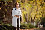 Portrait of a confident female doctor standing in a park.