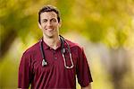 Portrait of a smiling male nurse with a stethoscope around his neck.