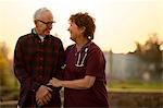 Smiling nurse comforting an elderly patient.