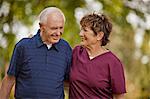 Mature nurse walking with a senior patient.