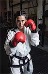 Portrait of woman in boxing gloves at fitness studio