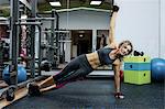 Woman performing stretching exercise in gym