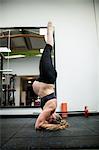 Pregnant woman performing yoga in gym