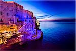 Cliff Restaurant Grotta Palazzese at Dusk in Polignano a Mare, Puglia, Italy