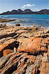 Lichen covered red granite rocks at the Hazards Mountain Range, Coles Bay, Freycinet Peninsula, Freycinet National Park, Tasmania, Australia, Pacific