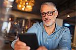 Man texting with cell phone in restaurant