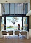 Businesswoman working at dining table in luxury home showcase interior