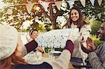 Woman receiving birthday gift at garden party