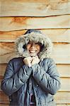 Portrait smiling woman wearing fur hood coat outside cabin