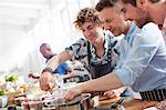 Male students in cooking class kitchen