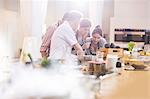 Teacher and students in cooking class kitchen