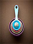 Spotted egg in multicolor nesting measuring spoons