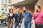 Group of friends walking on sidewalk