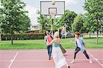 Friends playing basketball