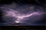 Lightning sparks from a spinning supercell thunderstorm at night near Leoti, Kansas