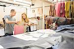 Man and woman having discussion in leather jacket manufacturers