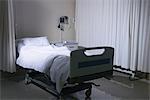 Empty unmade hospital bed in hospital ward