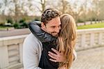 Romantic young couple hugging in Battersea Park, London, UK