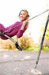 Portrait of teenage girl on swing