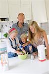 Family preparing food in kitchen