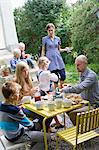 Family having lunch in back yard