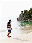 Boy walking on beach