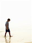 Boy walking on beach