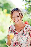 Young woman holding glass of juice