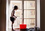Boy cleaning window