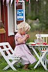 Girl playing in front of playhouse