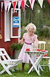 Girl playing in front of playhouse