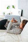 Woman on bed using cell phone