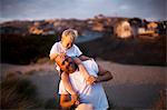 Man giving his son a shoulder ride on the beach