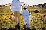 Two brothers in Easter costumes on an Easter egg hunt