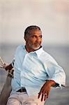 Mature man enjoying view of the water from a boat.