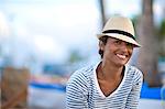 Portrait of mature woman smiling wearing fedora.