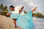 Happy mature couple dancing on the beach.