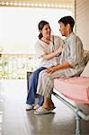 Nurse listening to her elderly patient's heartbeat with stethoscope.