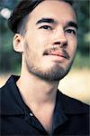 Portrait of pensive young man outdoors