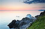 Remote house at the edge of cliff at dusk