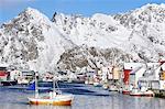 Fishing village with snow-capped mountains