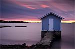 Wooden cottage on coastline