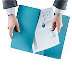 Businessman holding a financial report in a folder, hands close up, top view