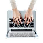 Business woman typing on a laptop keyboard on white background, top view, hands close up