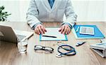 Professional doctor in his office working at desk, healthcare and hospitals concept